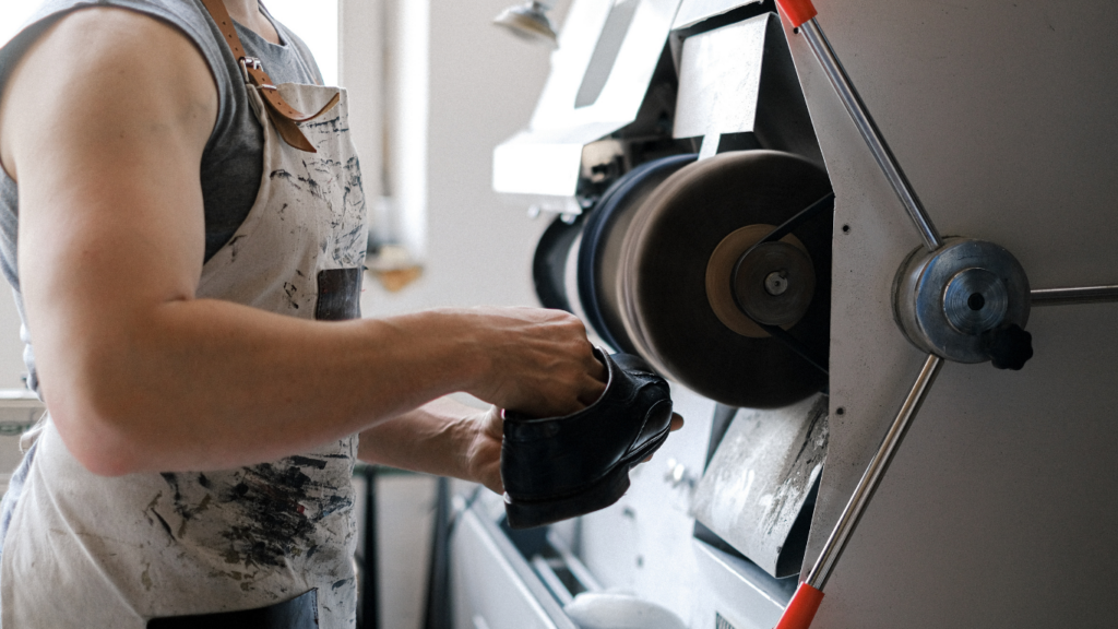 a person in an apron is working on a machine