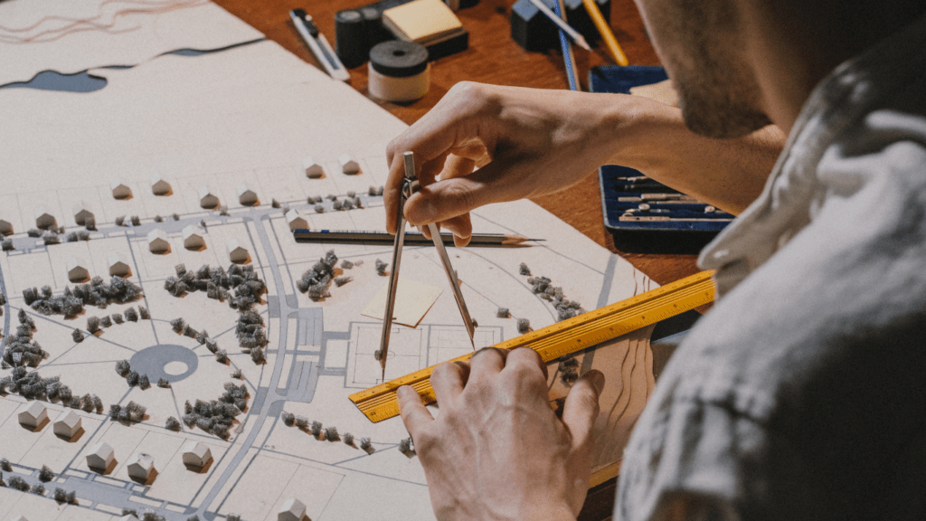 a person is working on a paper model of a city