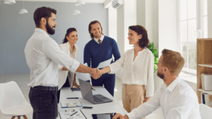 a group of business people shaking hands in an office