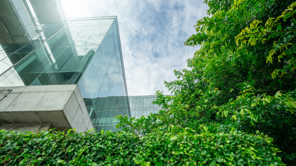 an office building with green trees and sky in the background