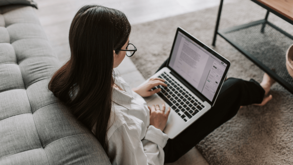 a person sitting on the floor using a laptop