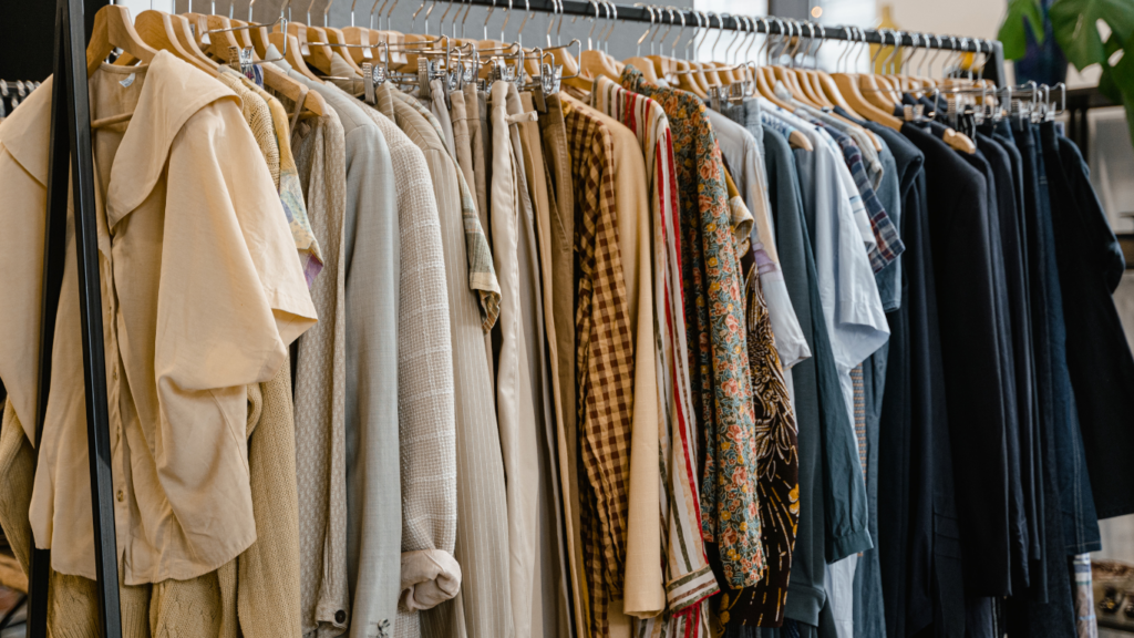 clothes hanging on hangers in a clothing store