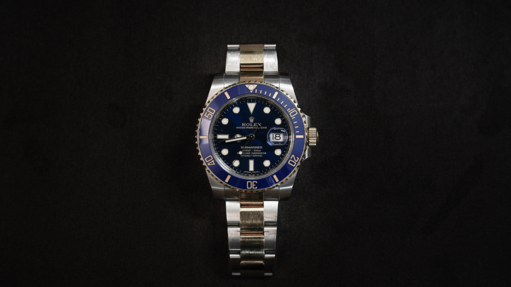 a rolex watch on a black background