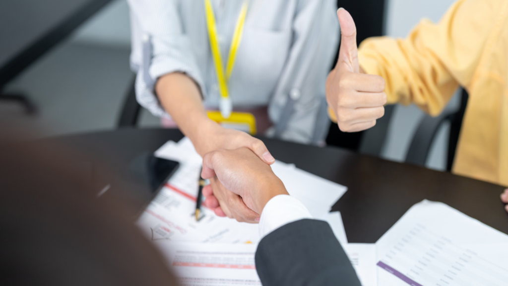 Two business people shaking hands in an office