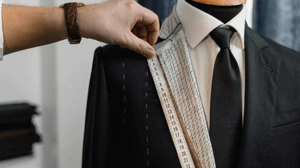 a person is measuring a suit