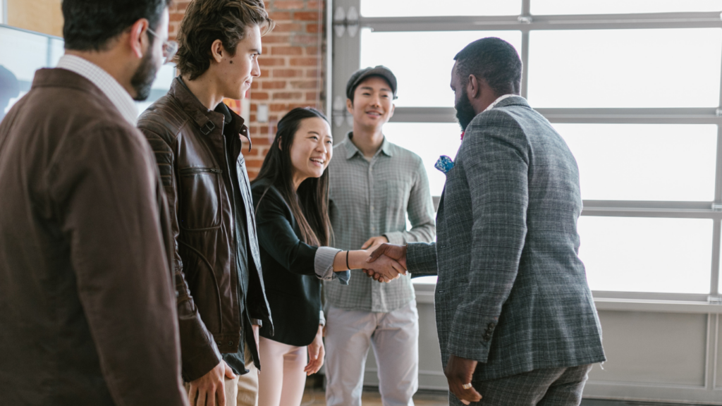 a group of business people shaking hands in an office