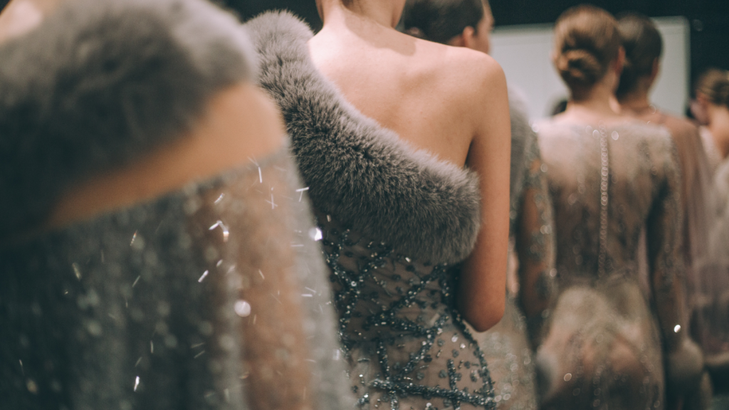 a group of people walking down the runway at a fashion show