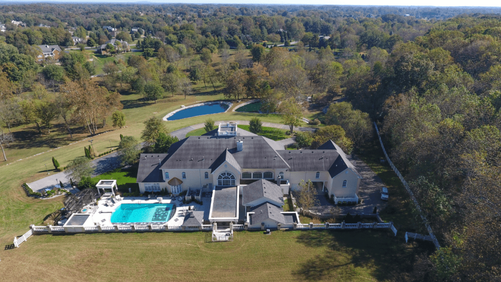 a large house with a swimming pool in front of it