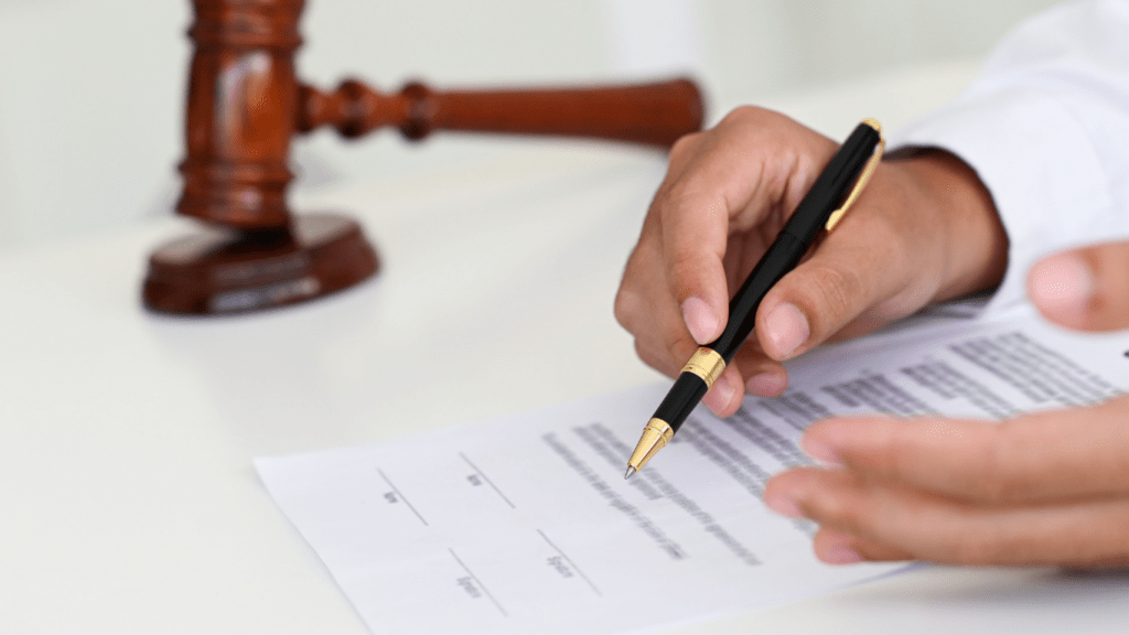 a person in a suit holding a gavel