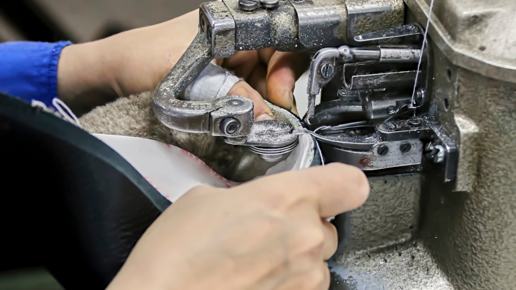 a person in an apron is working on a machine