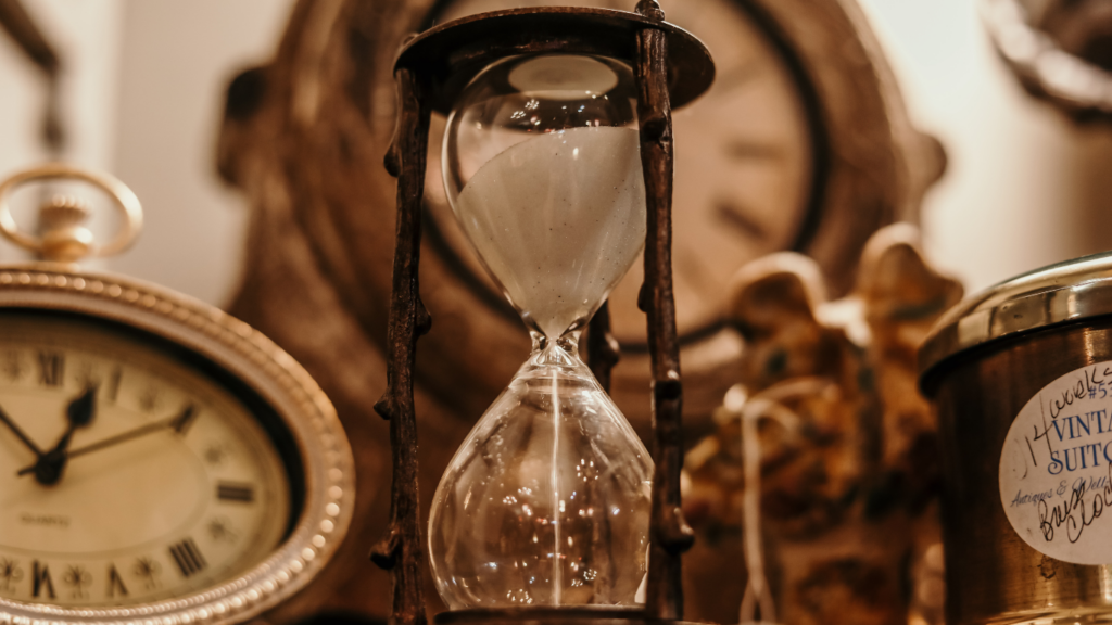 an hourglass sitting on top of a wooden table