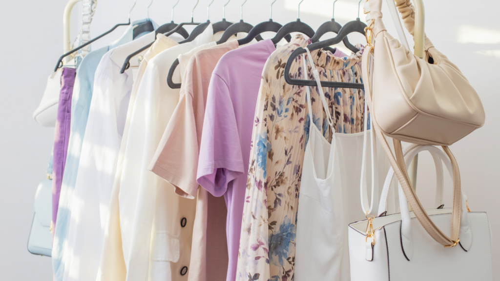 clothes hanging on hangers in a clothing store