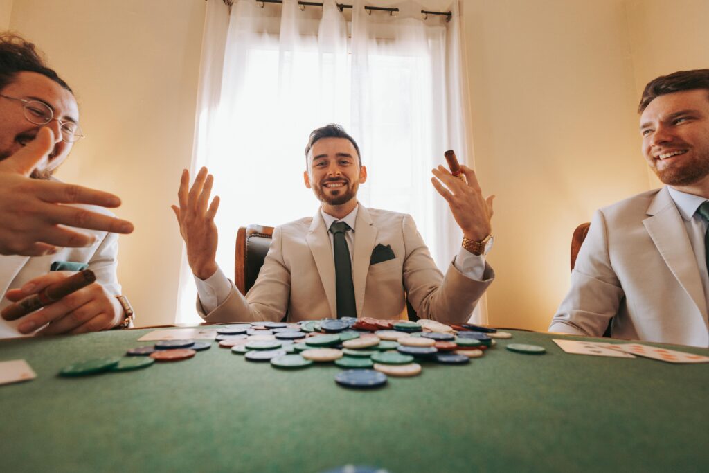 Three men in suits enjoying a poker game with chips and cigars.